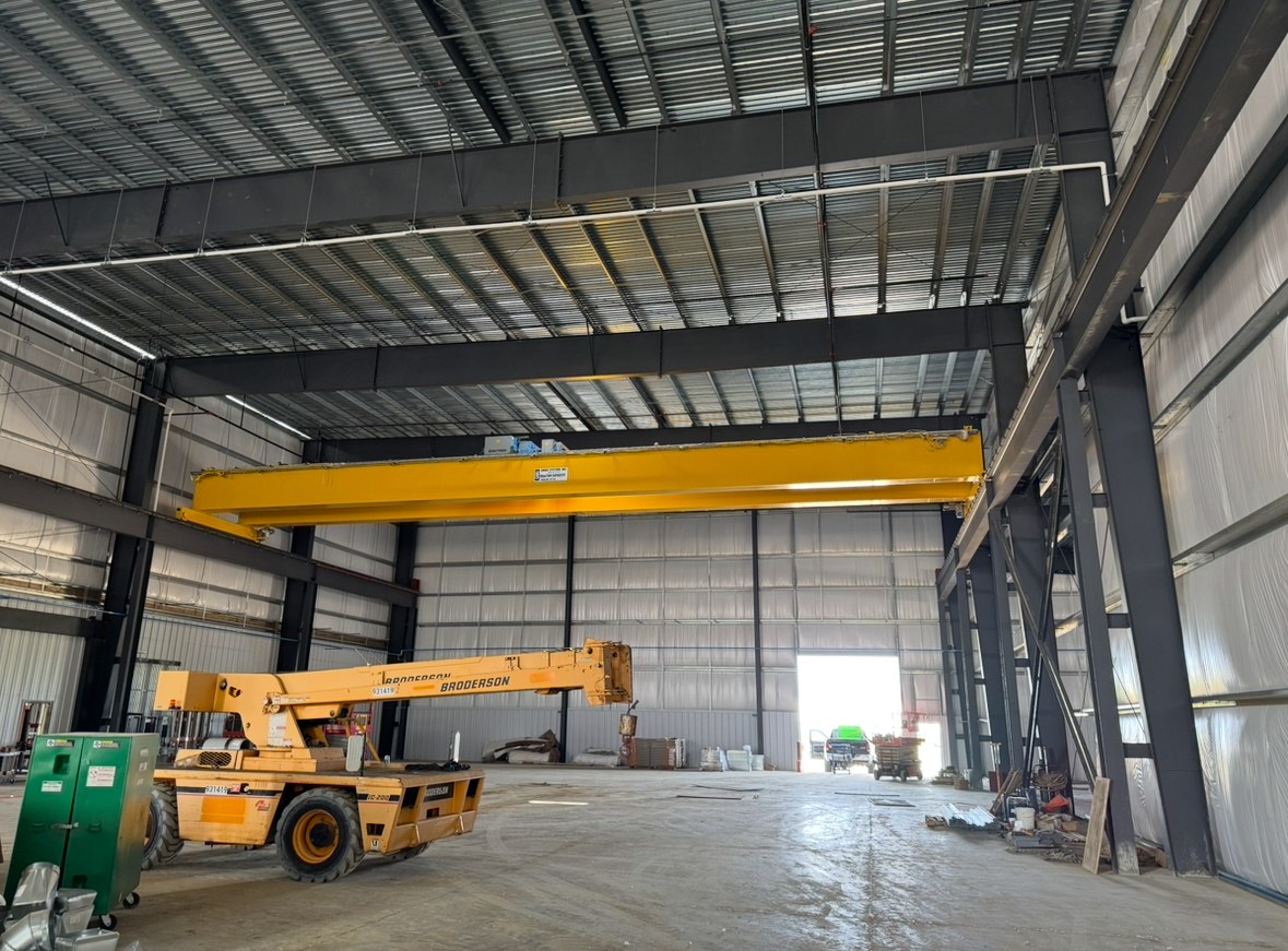The 40-ton bridge crane spans the building bay above the installation equipment.