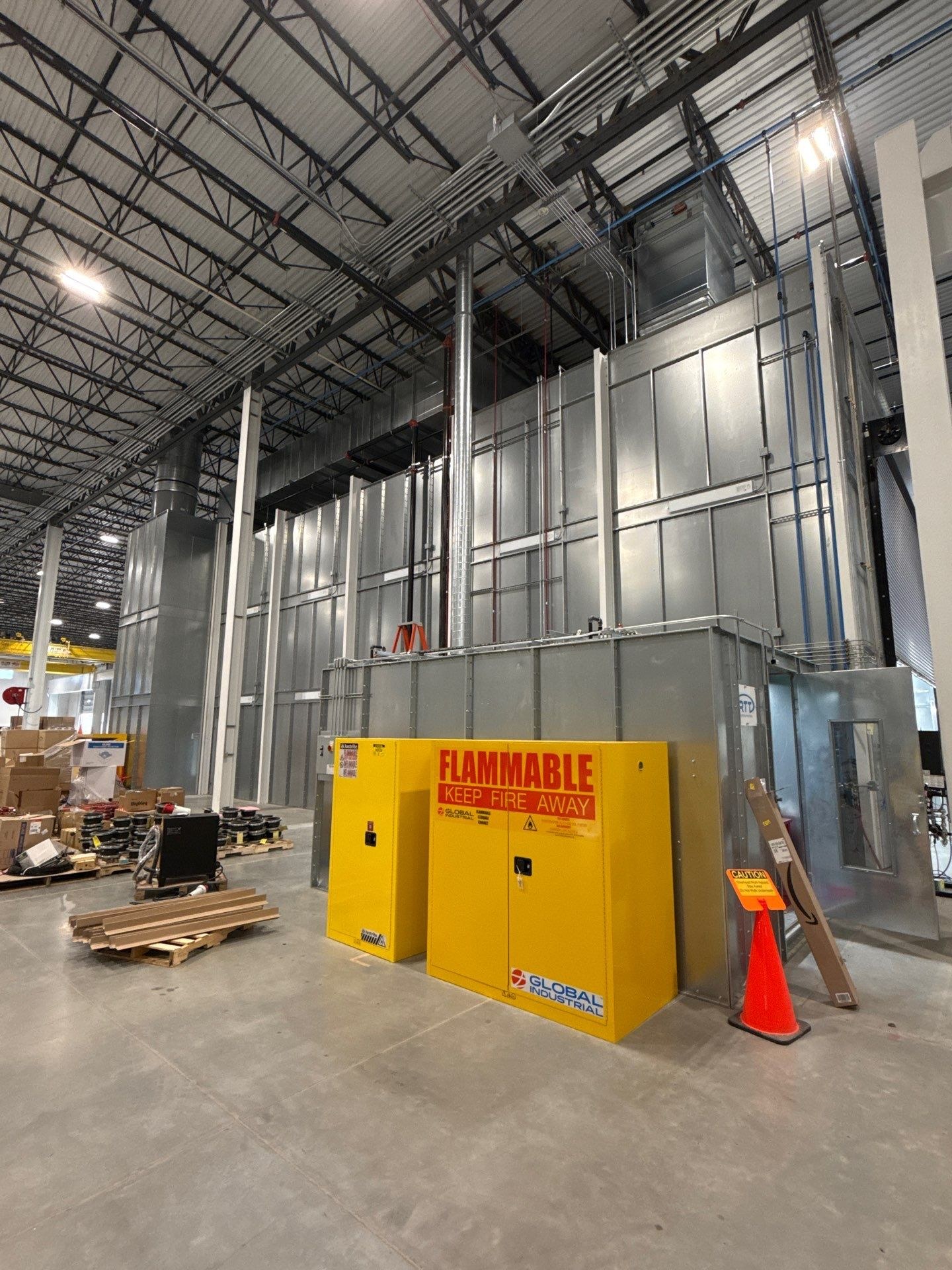 Mix-room exterior with connected ductwork, pipework, and storage cabinets.