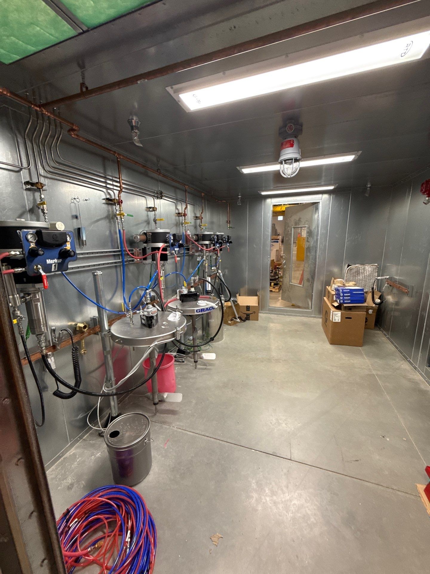 Paint-handling equipment and connected pipework inside the mix room.
