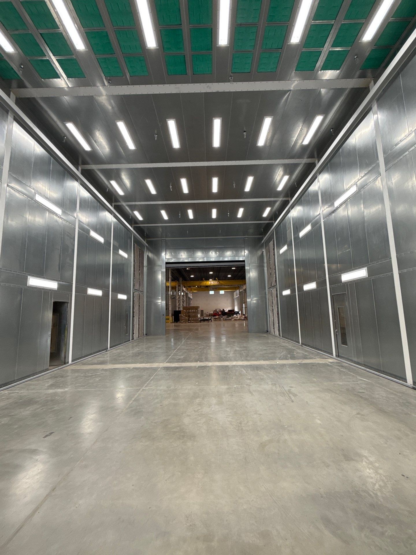 Completed booth interior with illuminated ceiling and wall panels and a clear central floor.