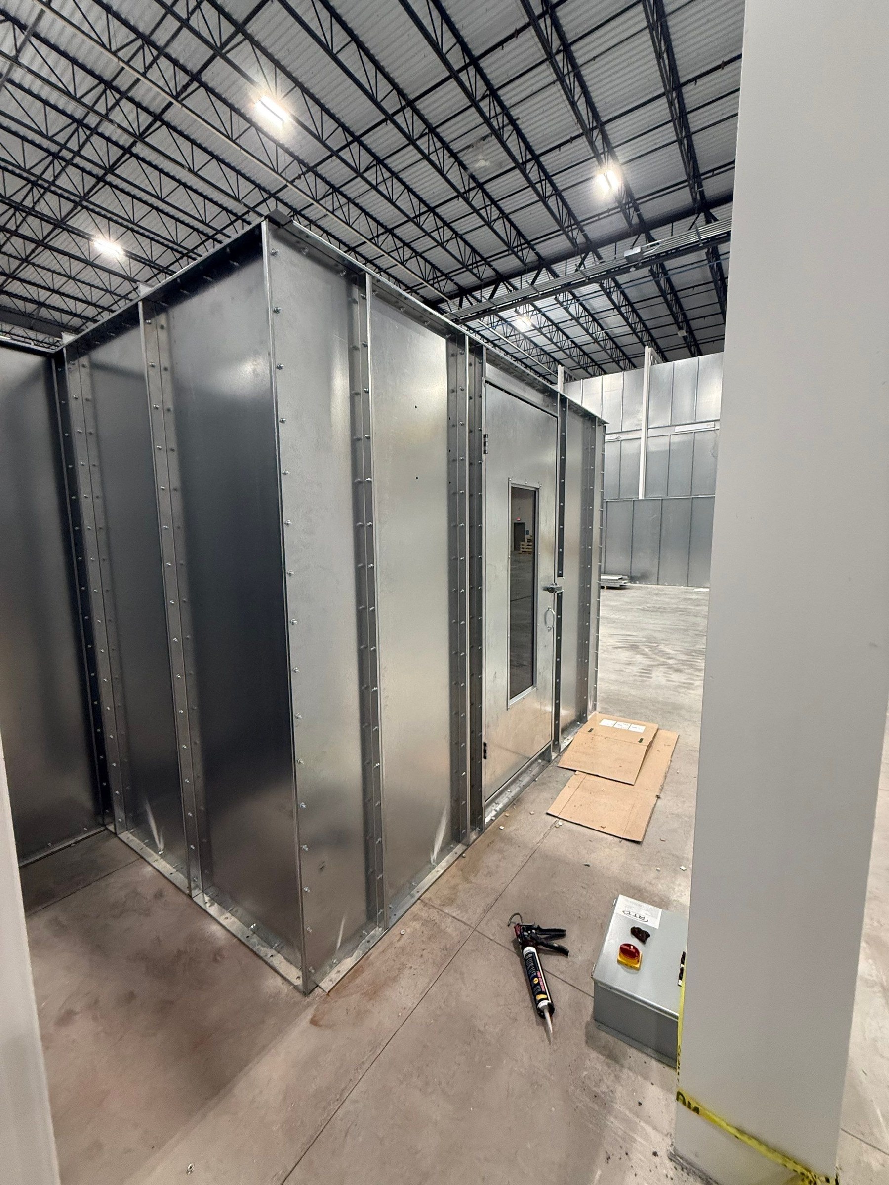 Mix-room shell and personnel door during assembly.