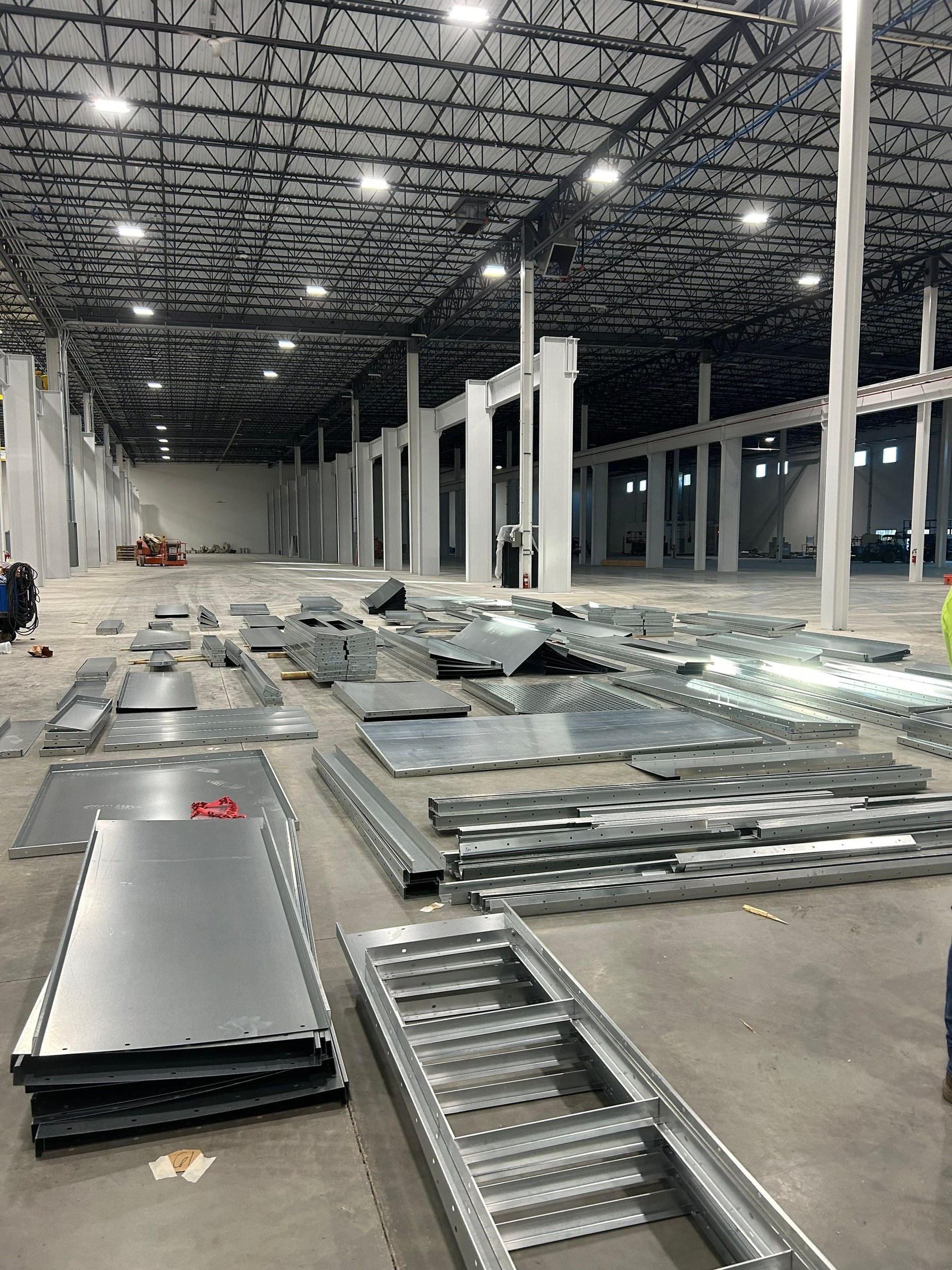 Booth panels and frame sections staged on the installation floor.