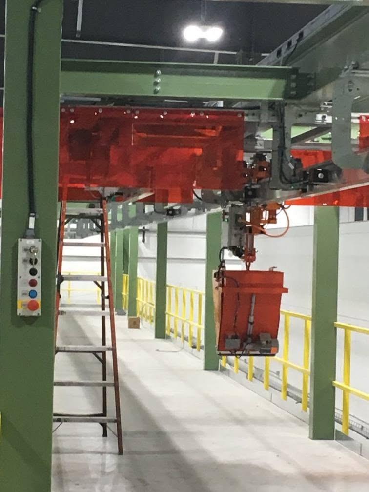Electric monorail equipment beside the platform, with a local control station on the support column.