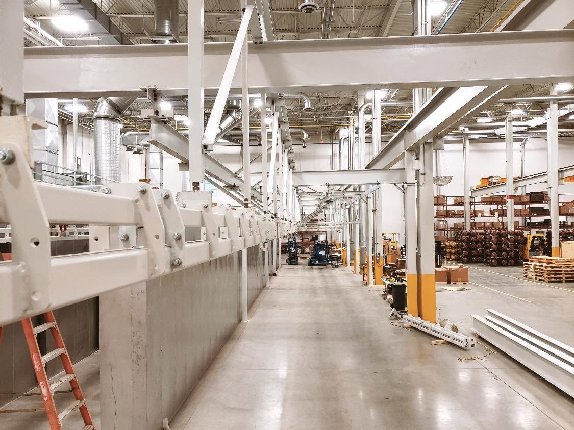 A view along the overhead conveyor route beside the process enclosure in Gainesville.