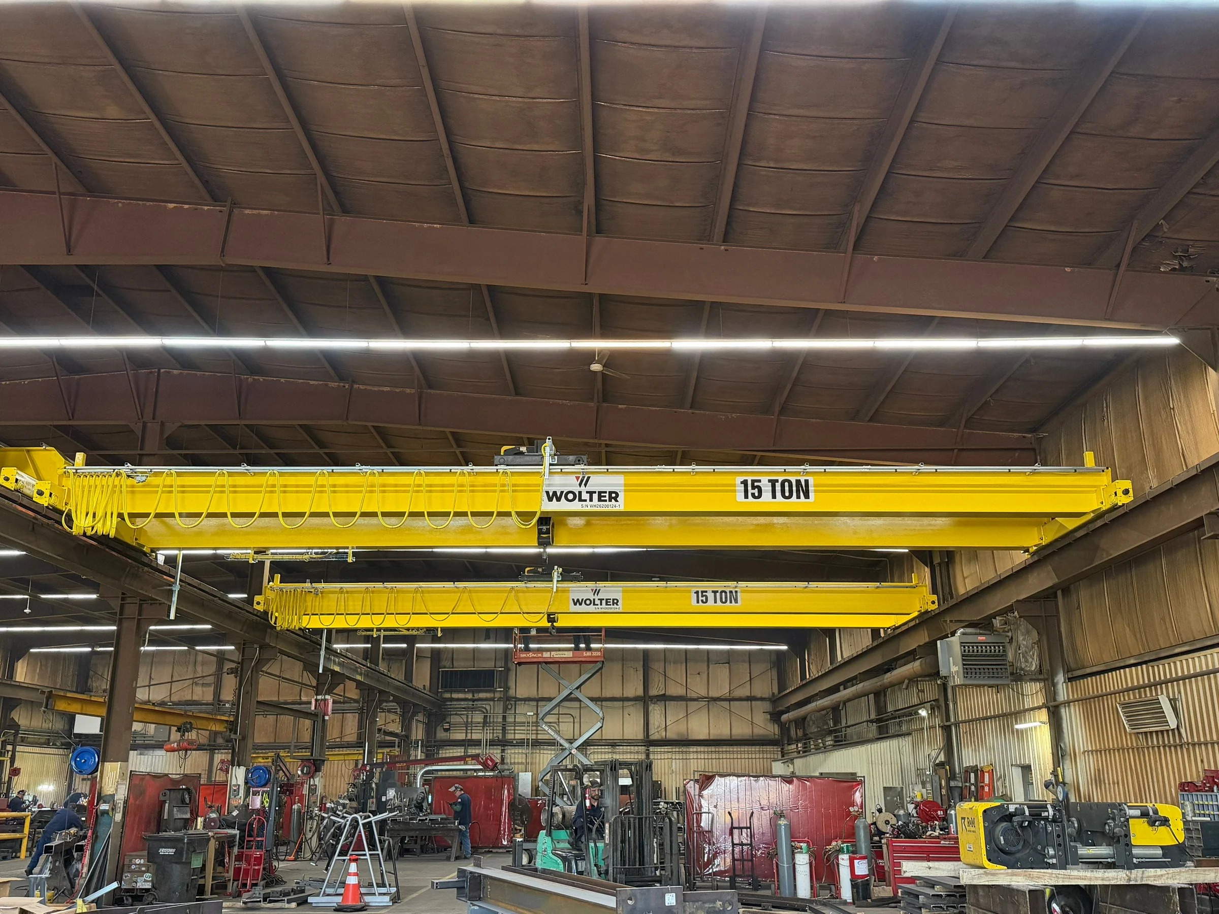 Two new Wolter-branded bridge cranes marked 15 ton spanning the Lejeune shop