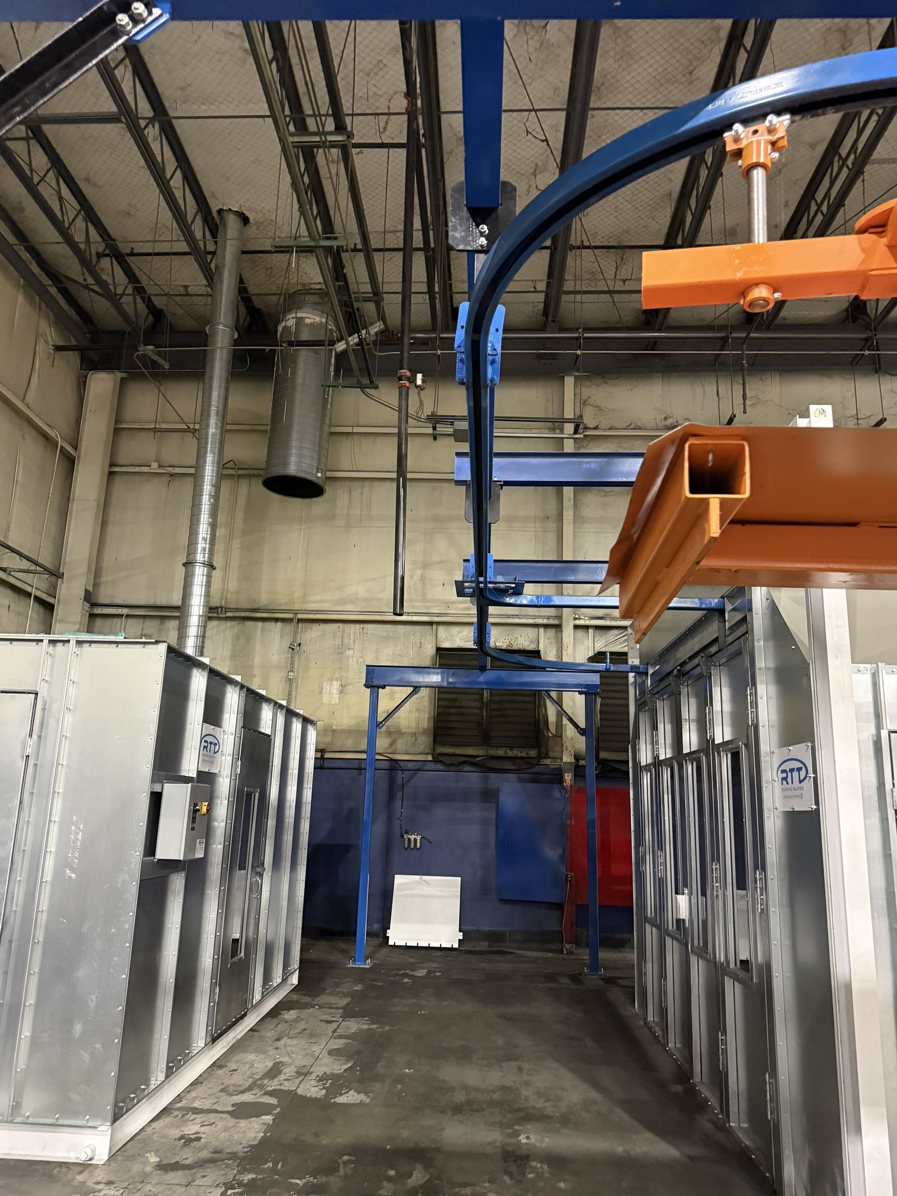 Overhead track curve and carrier clearance at the end of the finishing area.