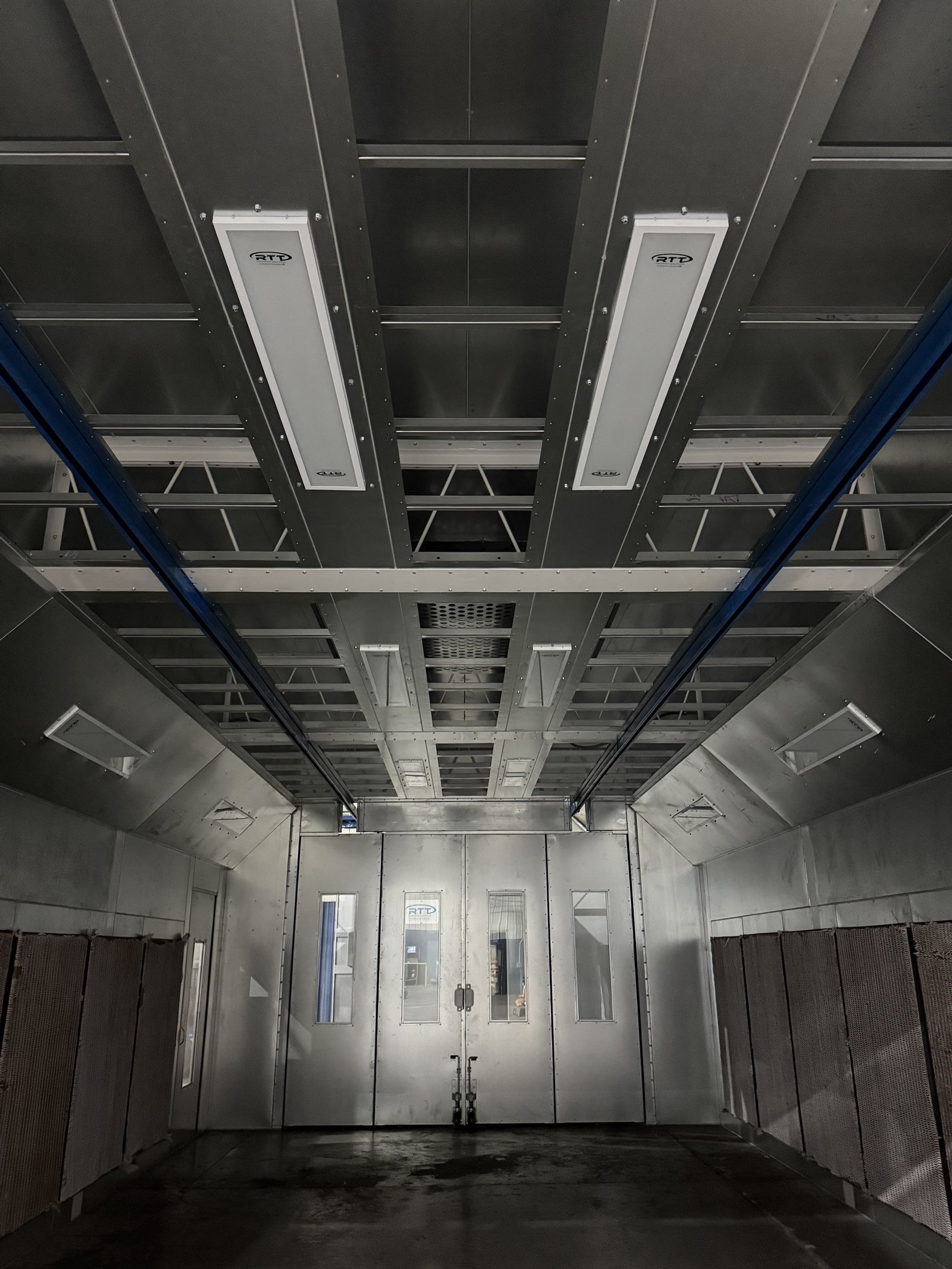 Ceiling panels and overhead track inside the finishing enclosure.