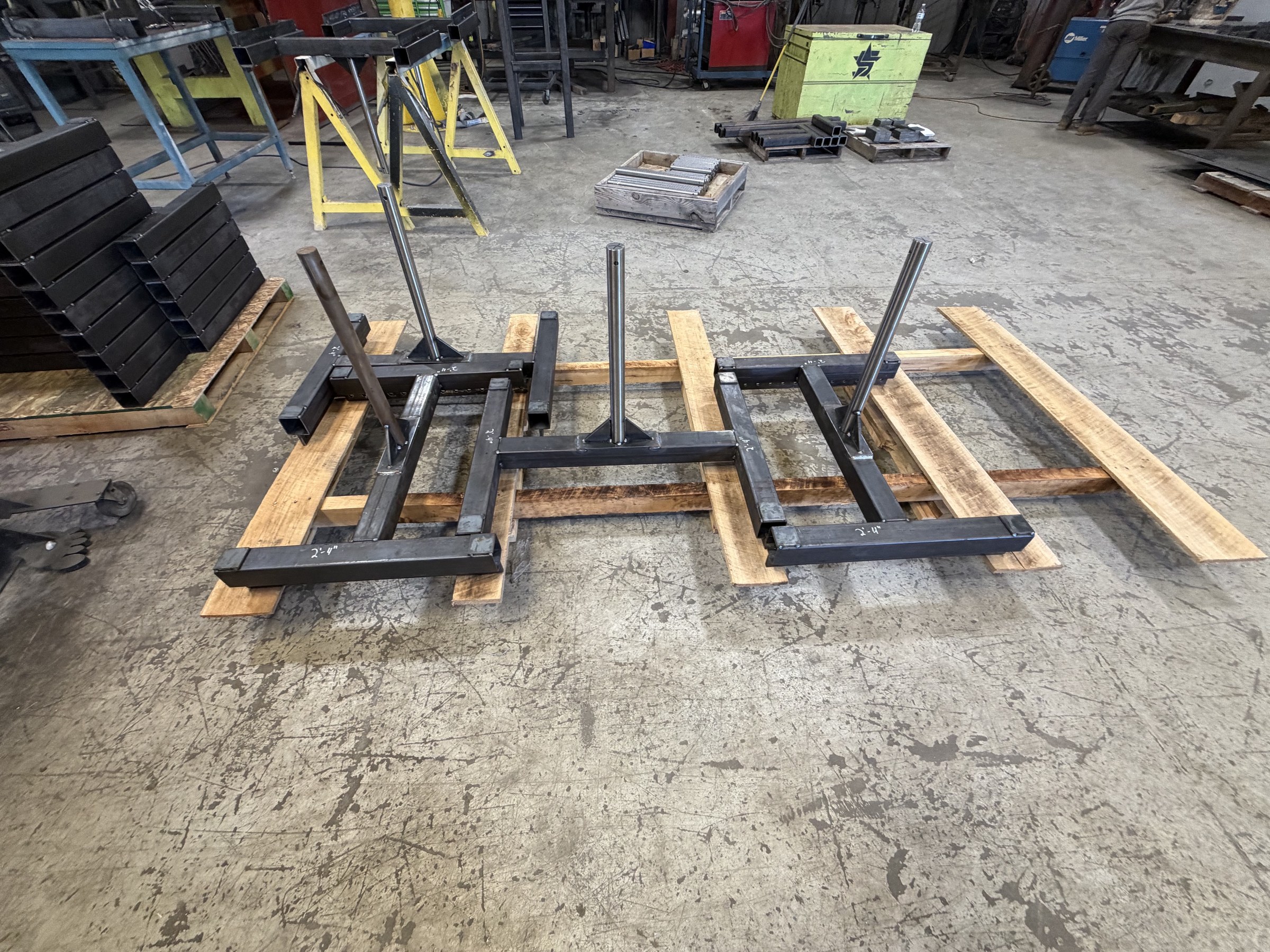 Steel carrier frames laid out in the fabrication shop.