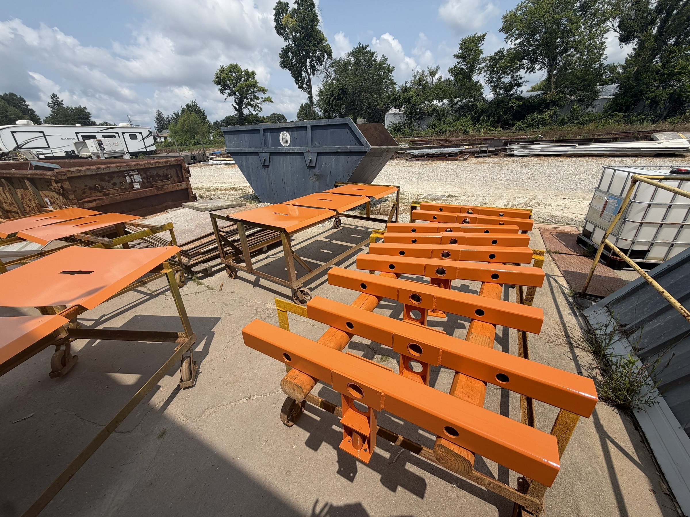 Rows of painted orange carrier assemblies before delivery.