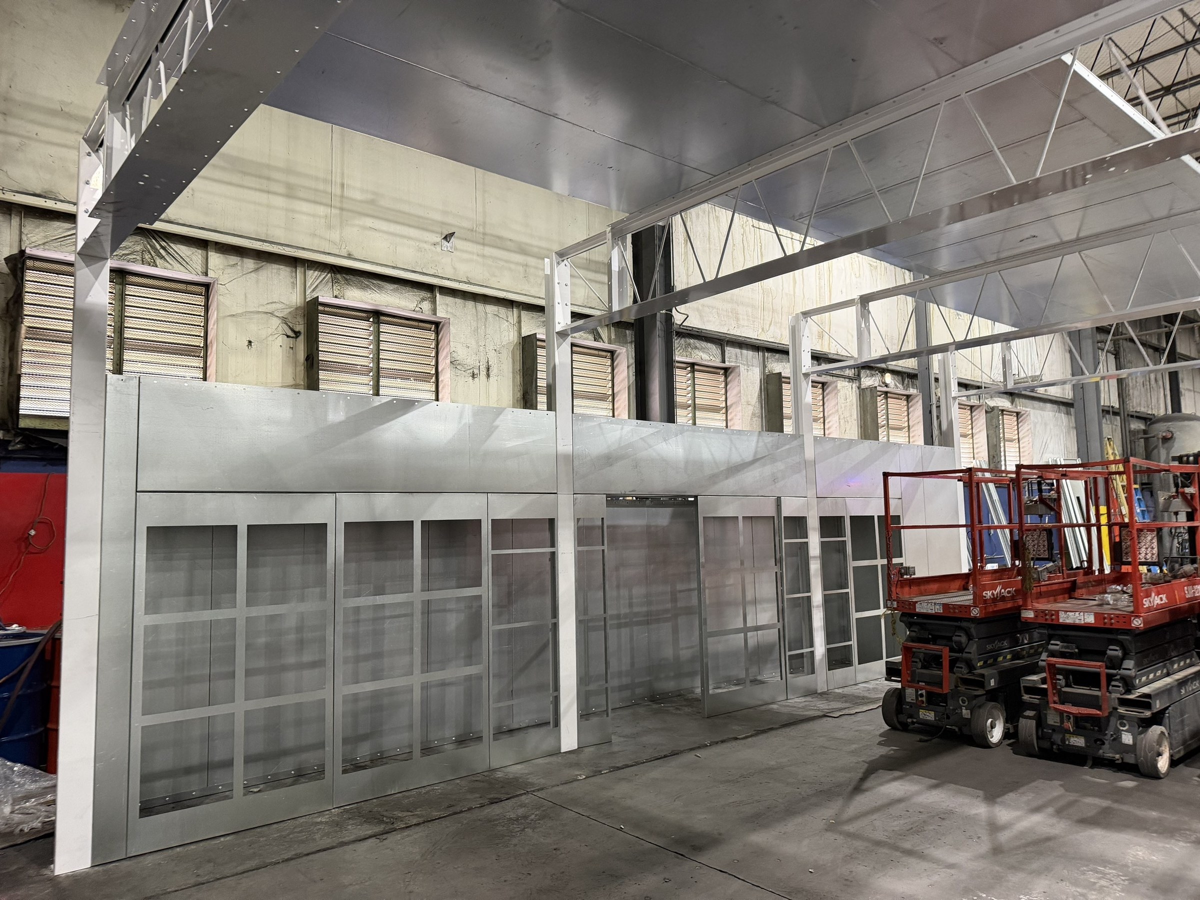 Ceiling and wall-panel assembly around the working scissor lift.