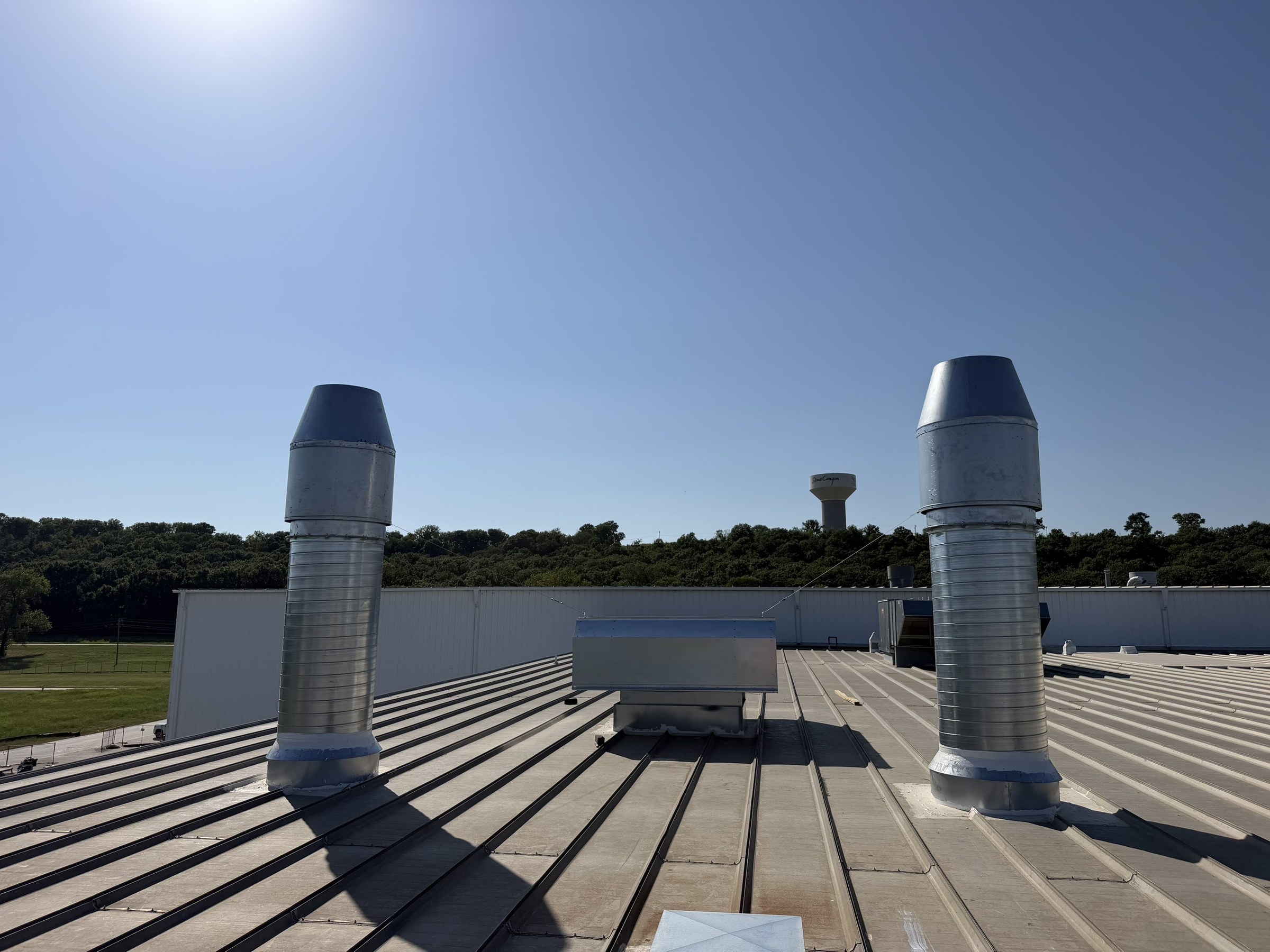 Rooftop exhaust stacks during the installation stage.