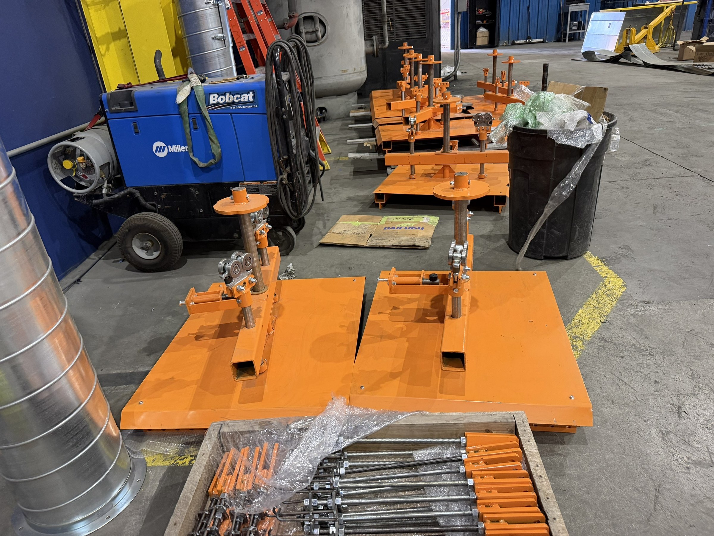 Orange carrier assemblies staged beside the installation work.