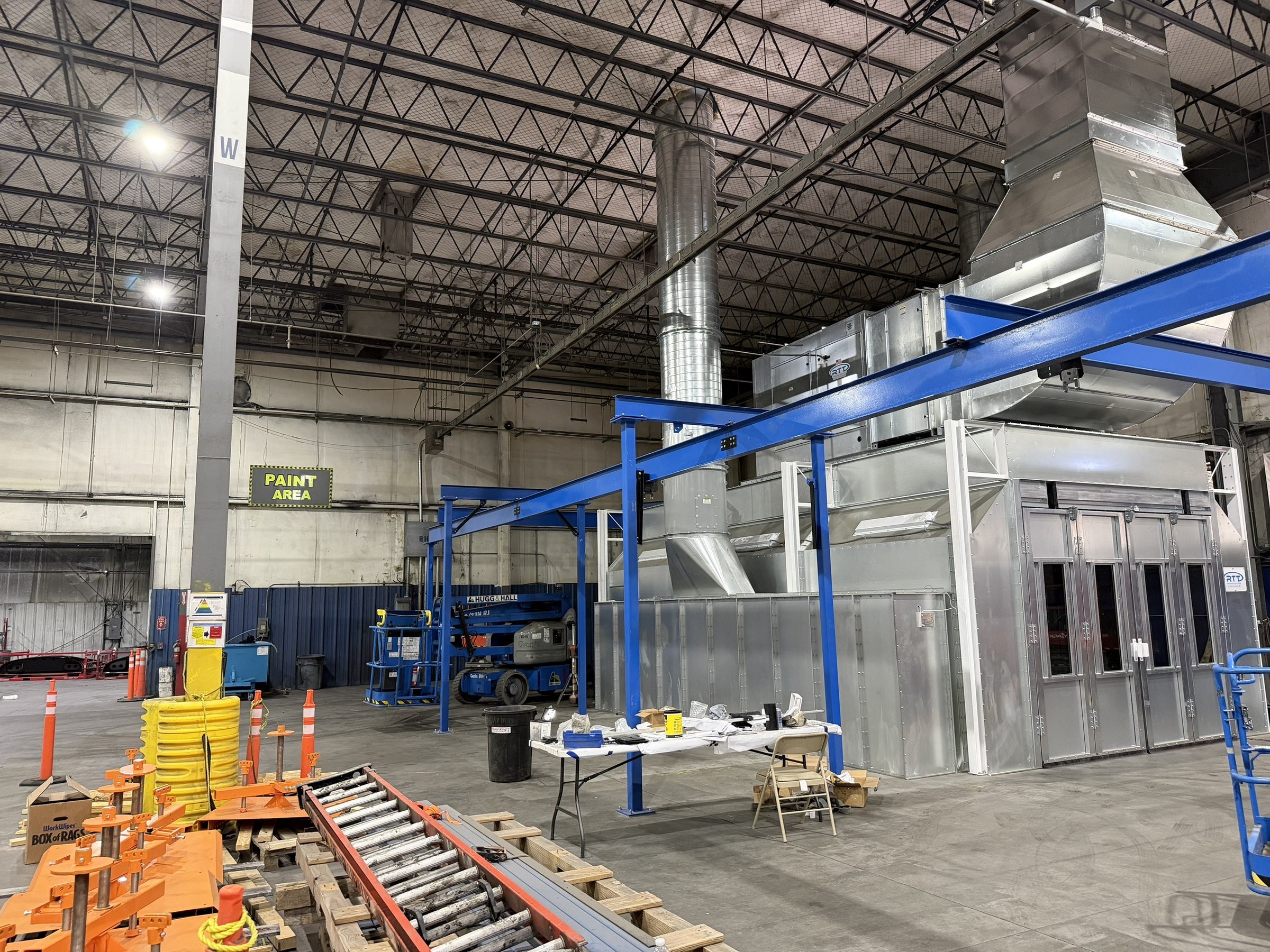 Conveyor support steel, booth ductwork, and carriers coming together on site.