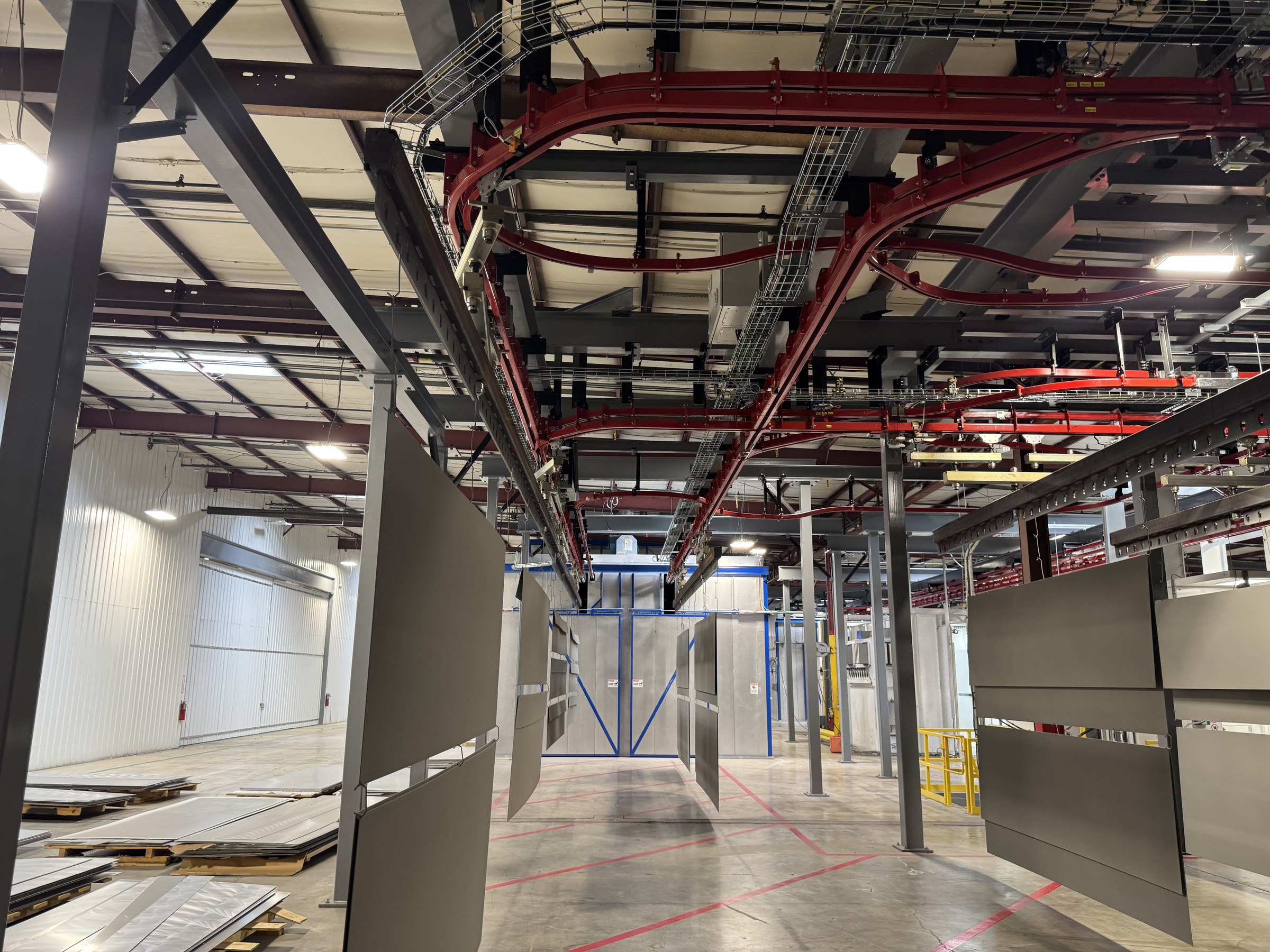 View through the installed track curves, supporting steel, and hanging panel carriers.
