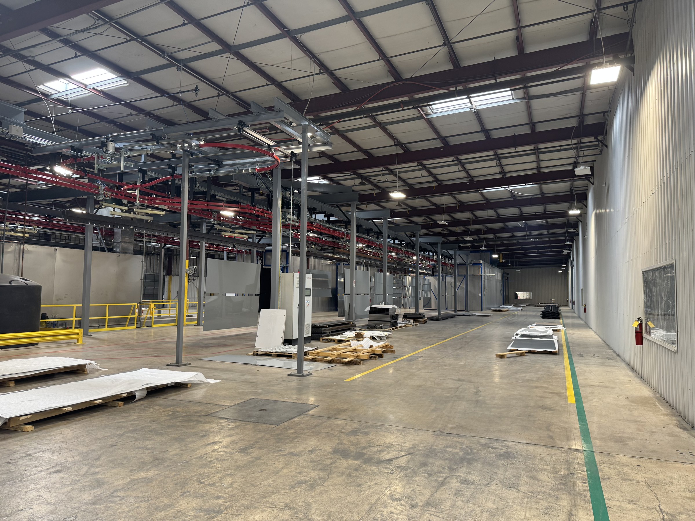 Full-length view of the conveyor installation beside the facility aisle.