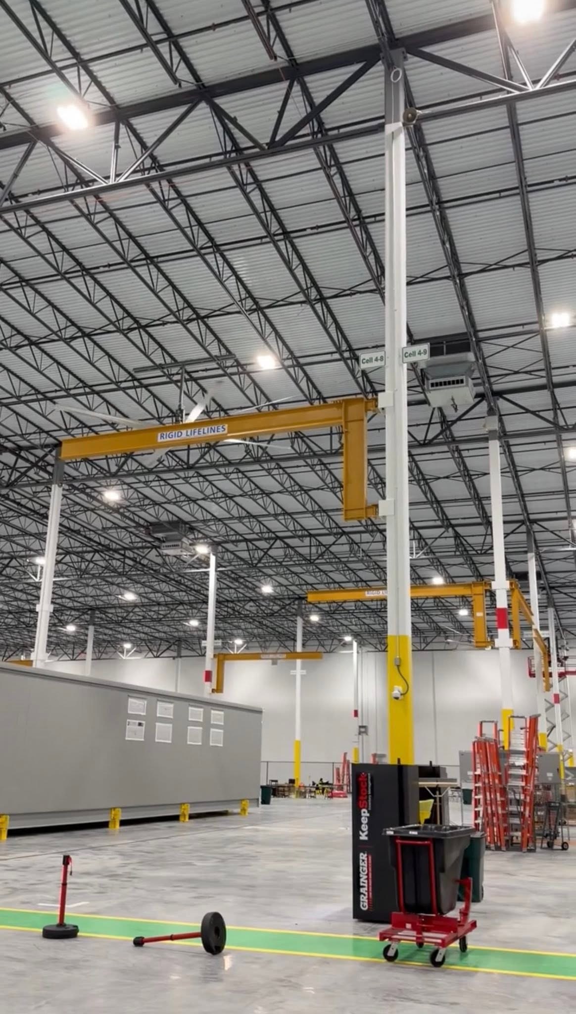 Multiple rigid-lifeline installations along the production floor.