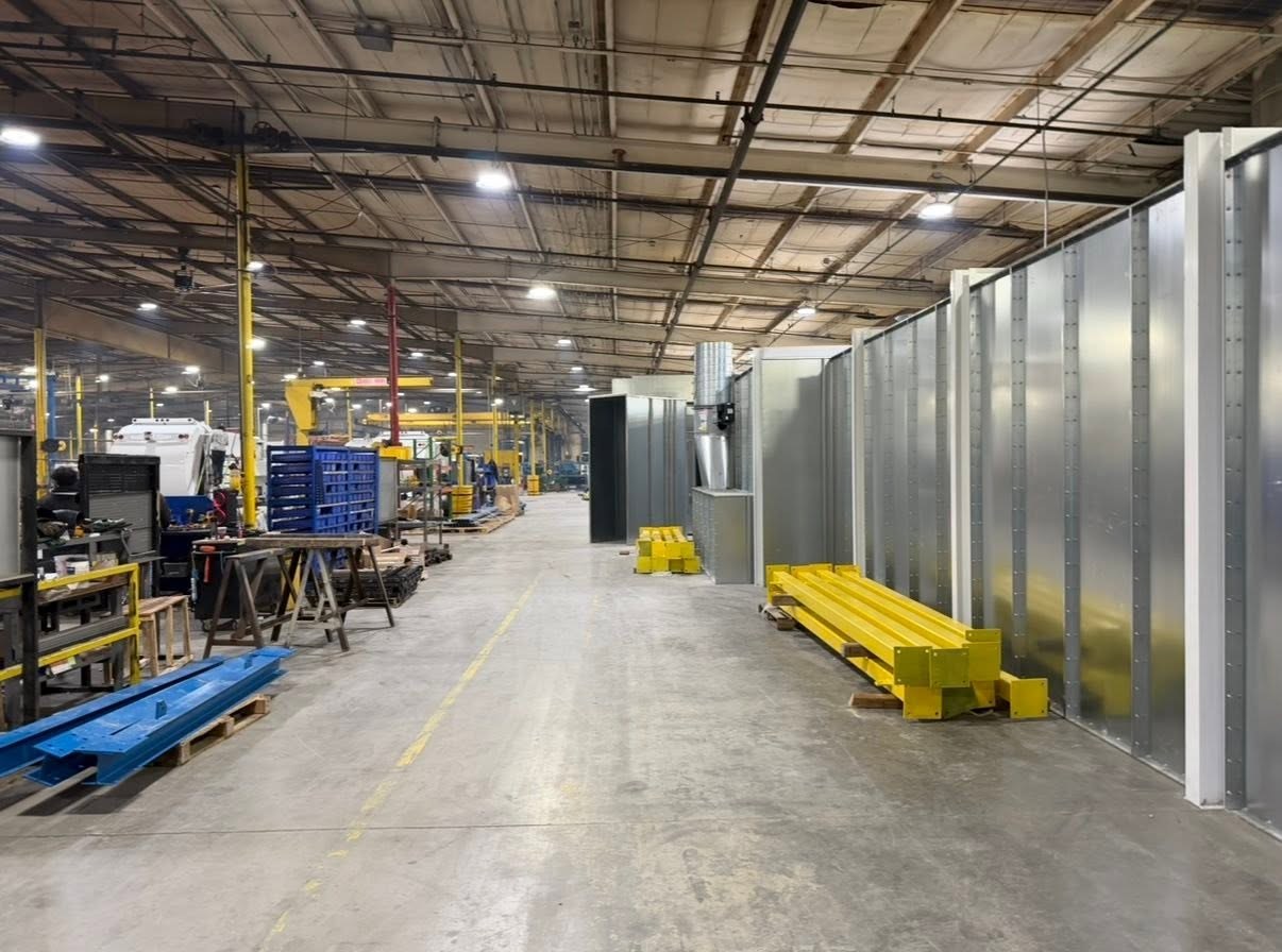 Support-steel components staged beside the RTT finishing equipment before conveyor assembly.