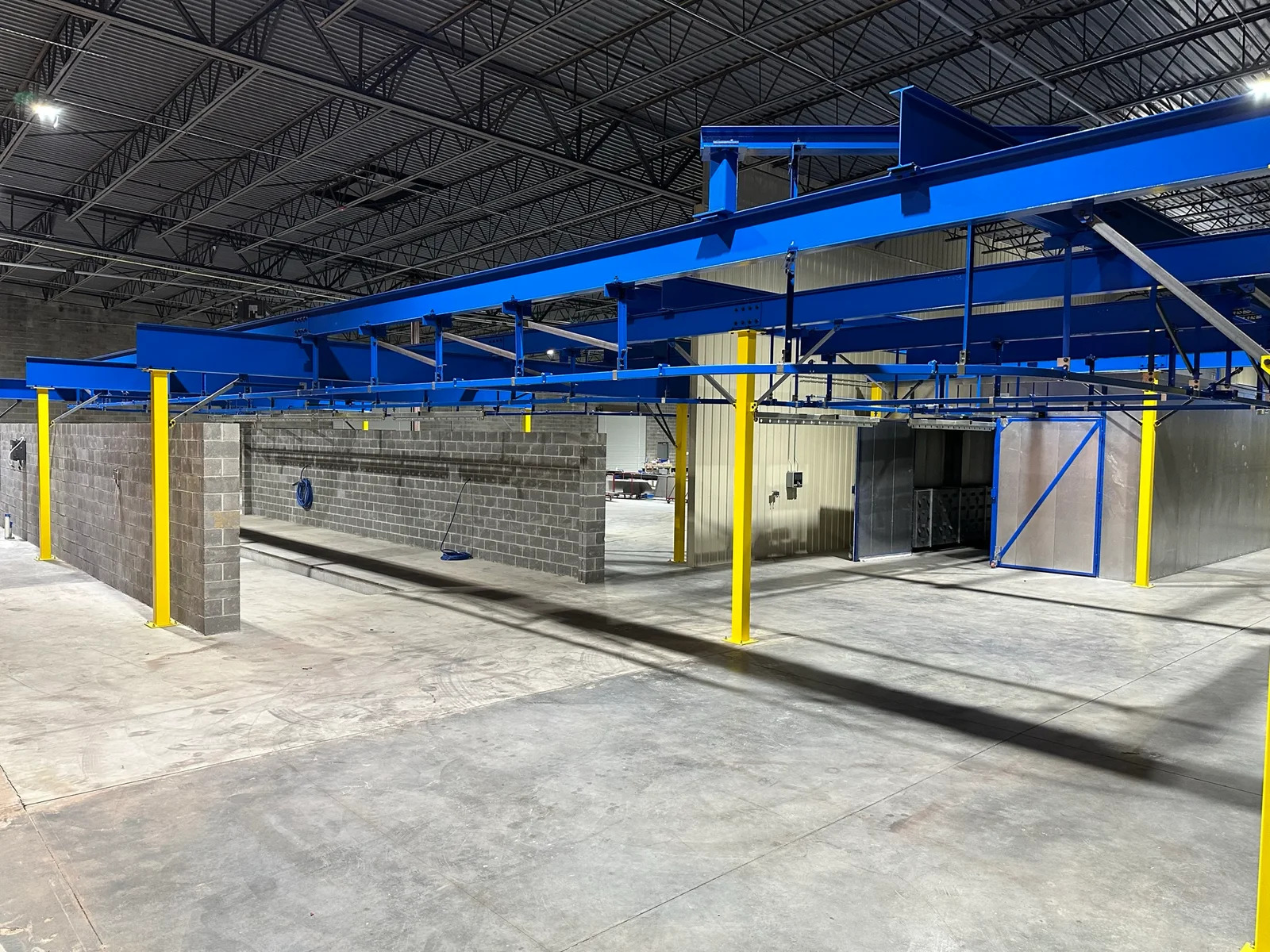Blue overhead support structure with open working space below