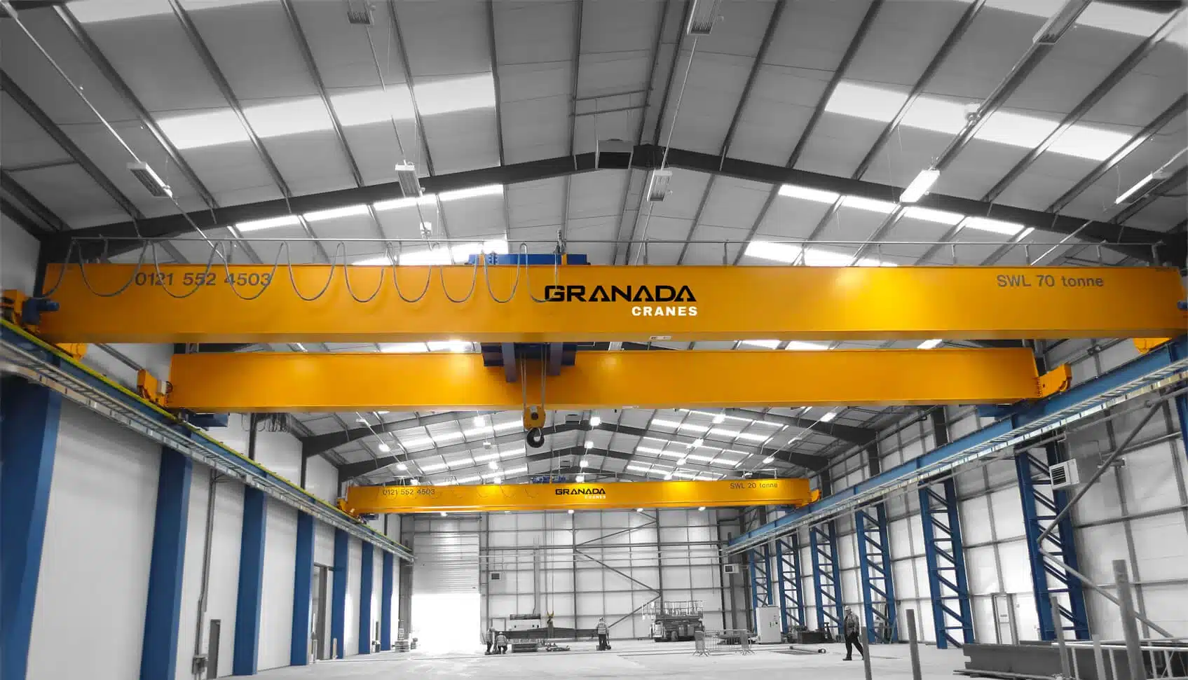 Bridge crane and industrial material handling equipment in a manufacturing facility