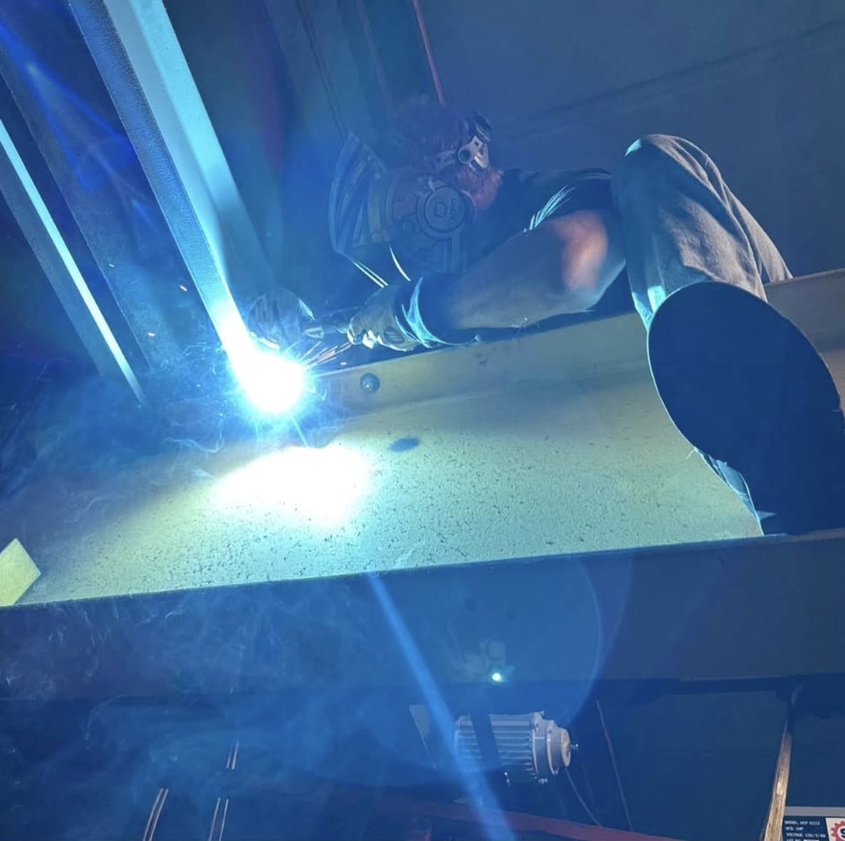 IMH field technician welding overhead steel