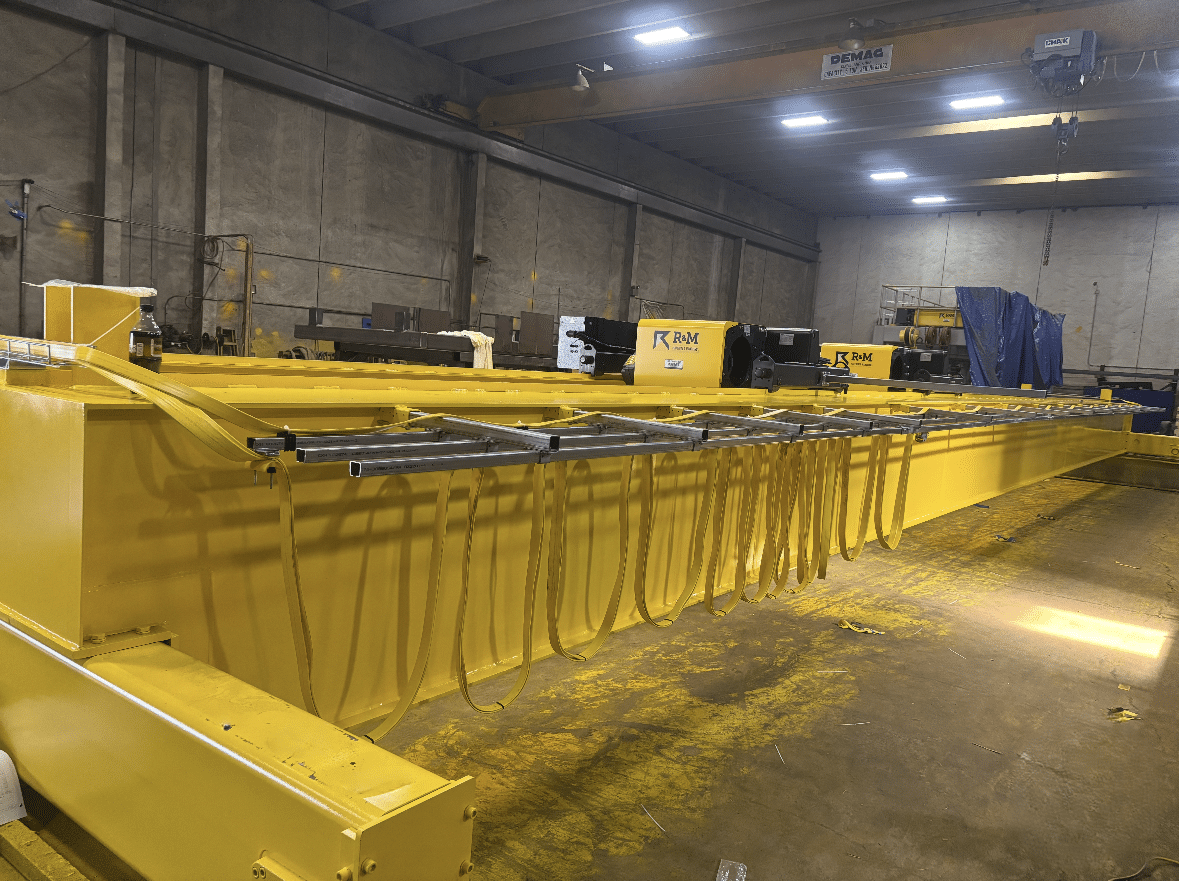 Double-girder crane assembly with electrification and hoist components