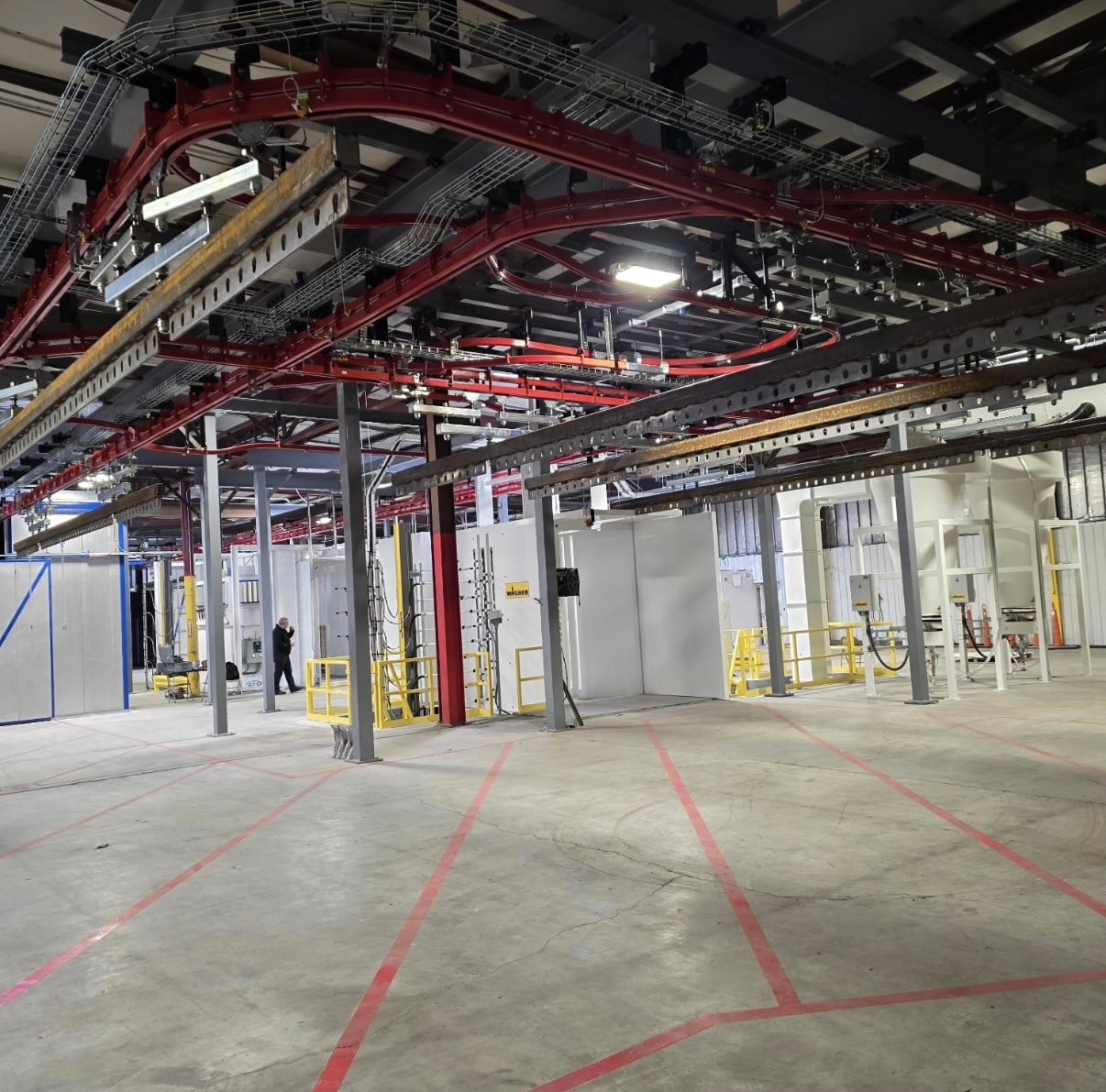 IMH Systems overhead conveyor installation inside a manufacturing facility