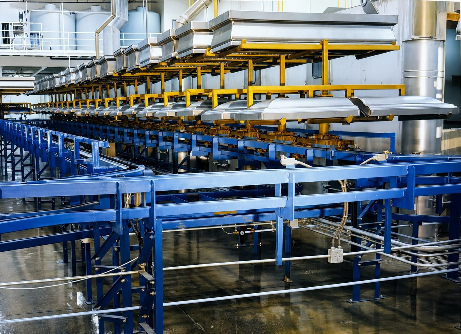 Inverted power and free conveyor system in a finishing process