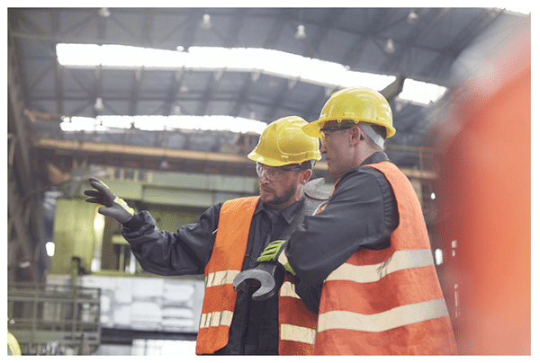 Maintenance technicians reviewing work in an industrial facility