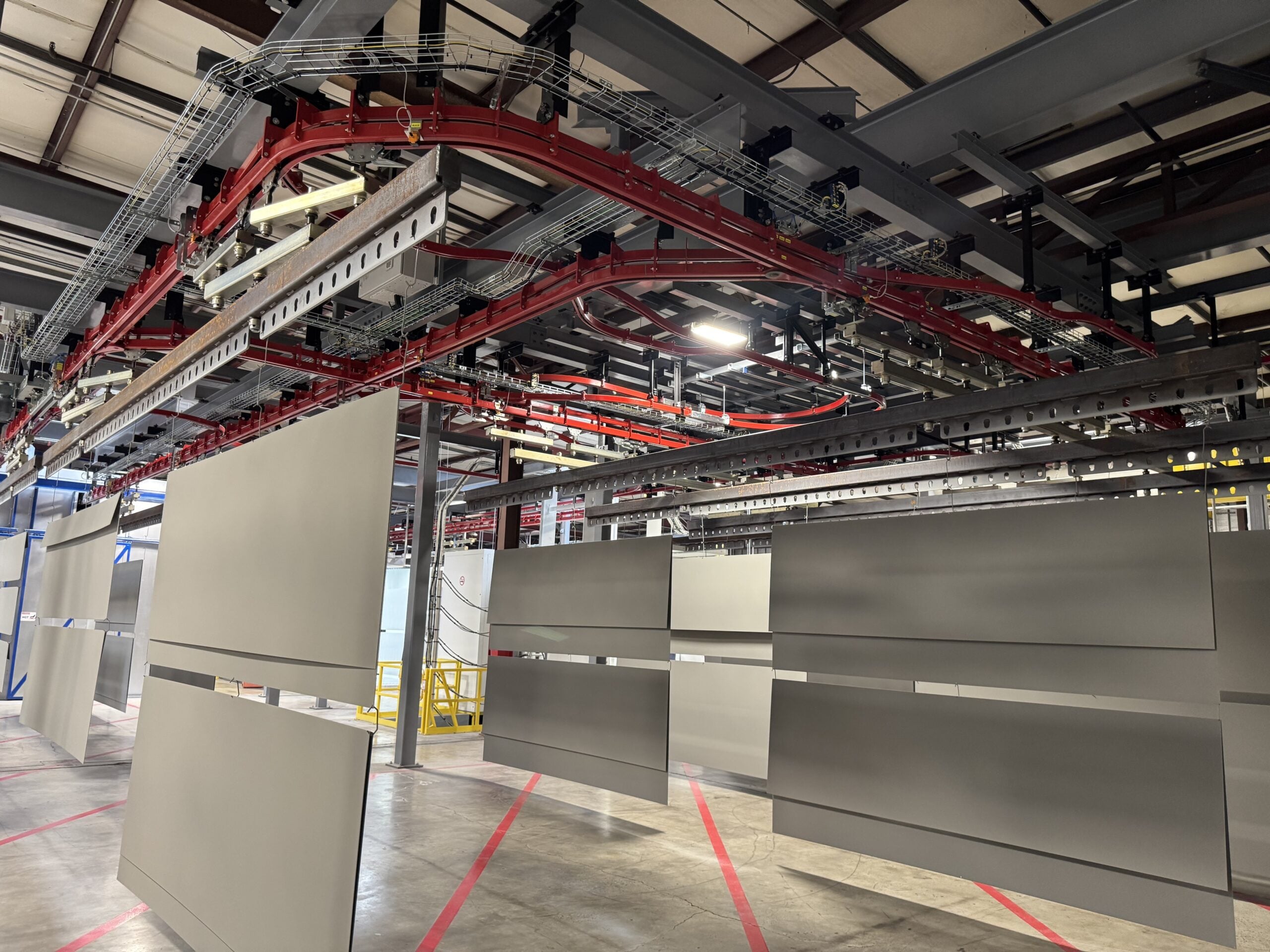Overhead power and free conveyor serving a production line