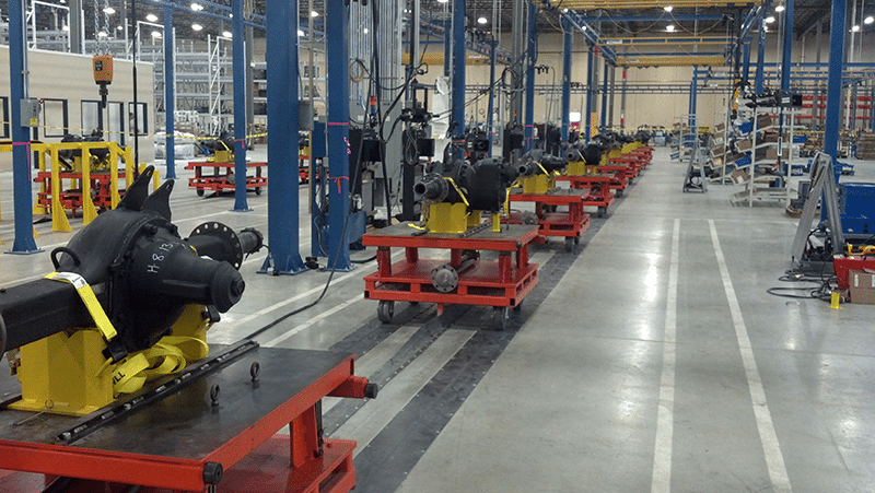 Towline conveyor system moving carts and fixtures through an industrial plant
