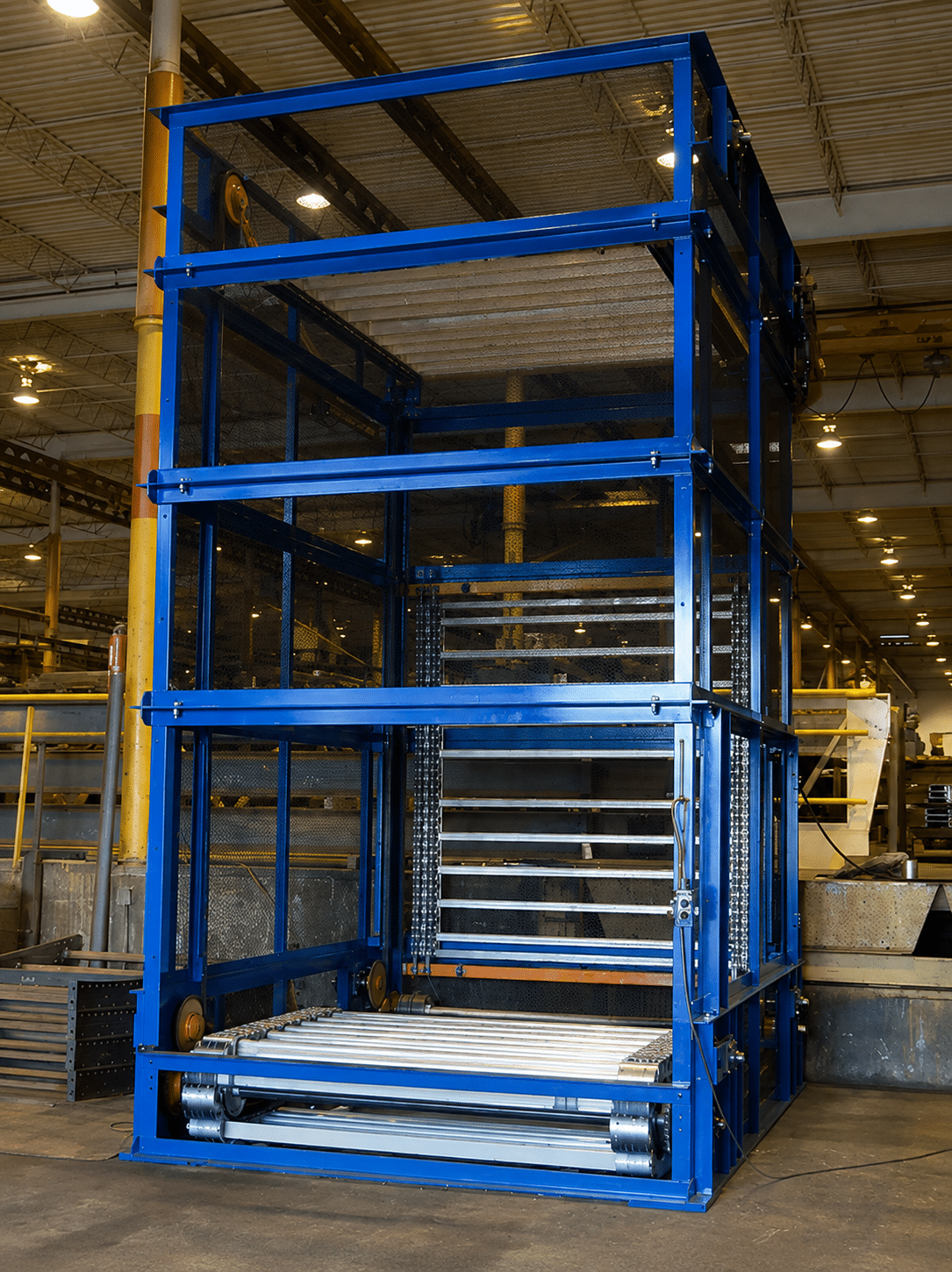 Blue vertical reciprocating conveyor (VRC) material lift with roller conveyor